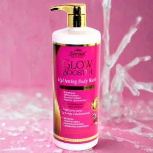 Zeenat Glow Booster Body Wash 1000 ml bottle with water splashes on pink background.