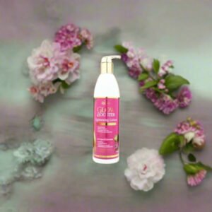 Zeenat Glow Booster and Hydrating Lotion 500ml bottle surrounded by soft pink flowers on a marble background.